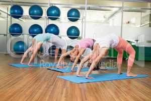 Yoga class in crab pose in fitness studio