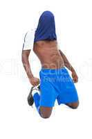 Football player in blue celebrating