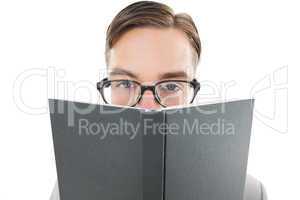 Geeky man looking over book