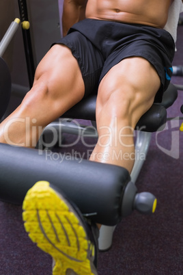 Mid section of muscular man doing a leg workout