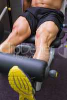 Mid section of muscular man doing a leg workout
