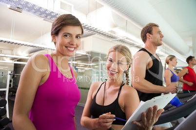 Trainer talking to her client on the treadmill