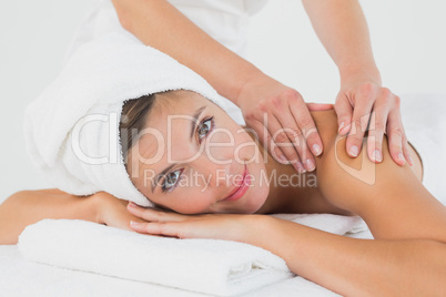 Attractive woman receiving shoulder massage at spa center