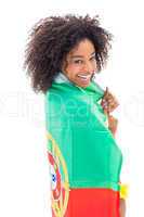 Girl wrapped up in portugal flag smiling at camera