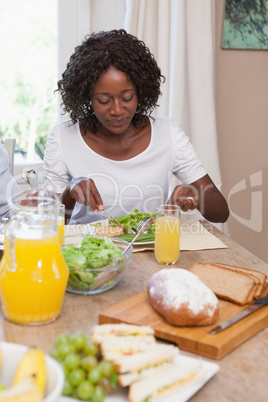 Family having lunch together of bread and salad