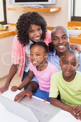 Happy family using the laptop together