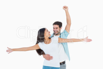 Happy casual couple cheering together