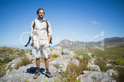 Handsome hiker standing at the summit