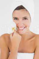 Close up of a beautiful young woman holding flower