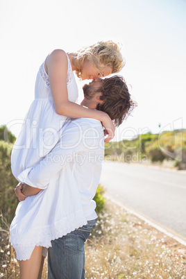 Attractive man lifting up his pretty girlfriend