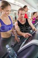 Trainer talking to his client on the treadmill