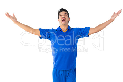 Happy football player in blue celebrating Happy football player in blue celebrating