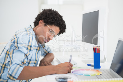 Young designer working at his desk