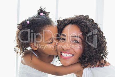 Pretty mother with her daughter kissing her cheek