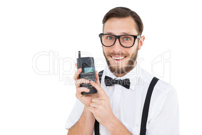 Geeky hipster holding a retro cellphone