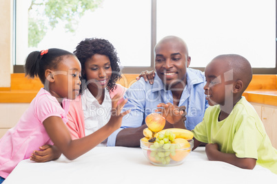 Happy family having fruit together