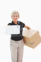 Happy delivery woman looking for signature