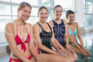Female aqua aerobics class smiling at camera