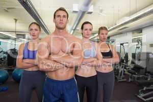 Serious fitness class posing together