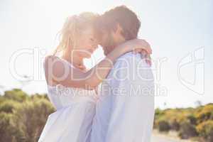 Attractive couple embracing by the road