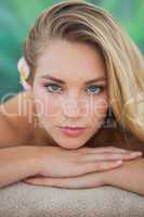 Peaceful blonde lying on towel looking at camera