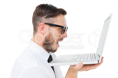 Geeky frustrated businessman looking at his laptop