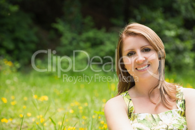 Cute young woman relaxing in field