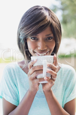 Pretty woman sitting outside having coffee