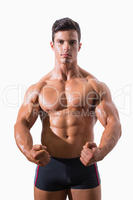 Portrait of a muscular man clenching fists