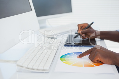 Designer sitting at his desk working with digitizer