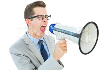 Geeky businessman shouting through megaphone