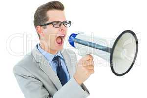 Geeky businessman shouting through megaphone