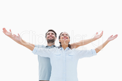 Cute couple standing with arms out