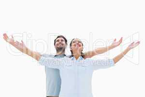 Cute couple standing with arms out