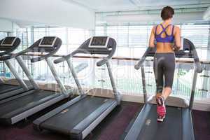 Fit brunette running on the treadmill