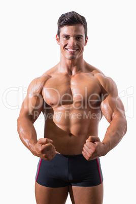 Portrait of a muscular young man clenching fists