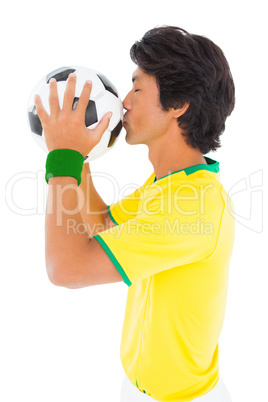 Football player in yellow kissing ball Football player in yellow kissing ball