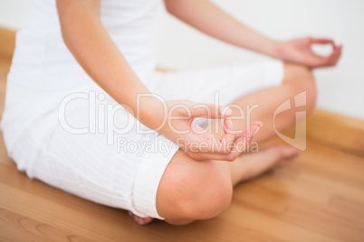 Peaceful woman sitting in lotus pose