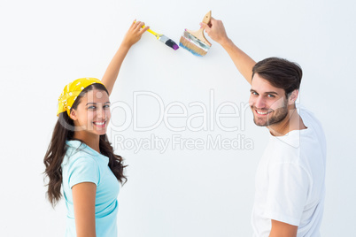 Happy young couple painting together