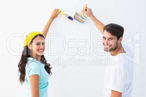 Happy young couple painting together