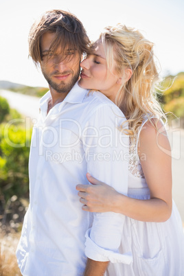 Attractive couple embracing by the road