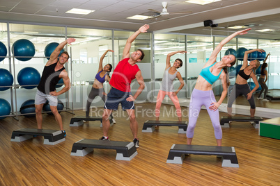 Fitness class doing step aerobics