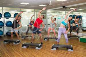 Fitness class doing step aerobics