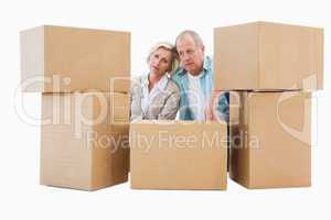 Stressed older couple with moving boxes