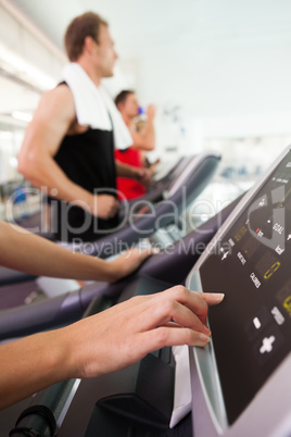 Row of people working out on treadmills