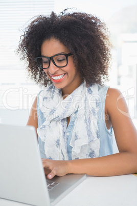 Pretty hipster working at her desk with laptop