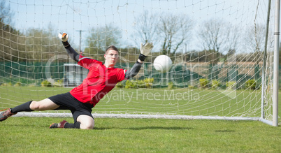 Goalkeeper in red ready to make a save