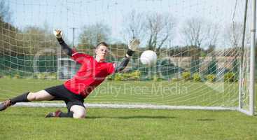 Goalkeeper in red ready to make a save