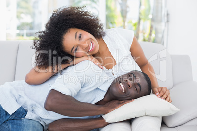 Attractive couple cuddling on the couch