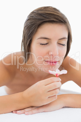 Close up of a beautiful woman smelling flower